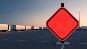 empty parking lot with a orange caution sign